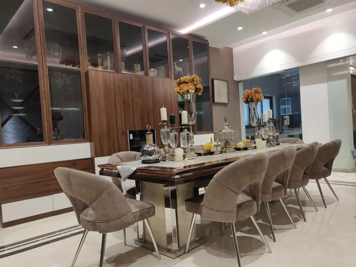 Dining room at Arif House with a marble-topped table and walnut display wall