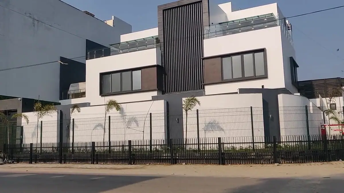 White and timber facade of Arif House seen from the street