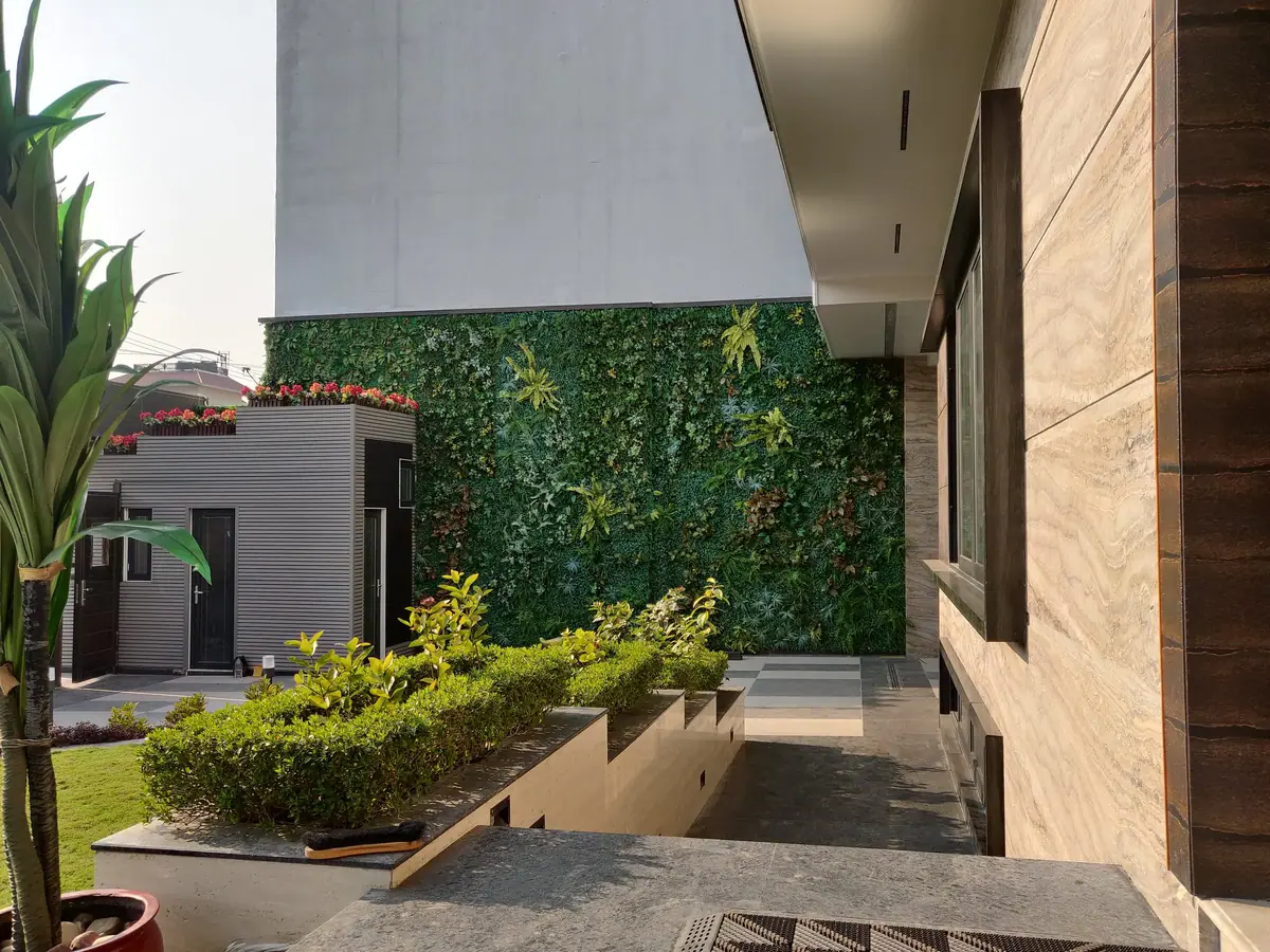 Living green wall and terraced planting beside the stone-clad wing