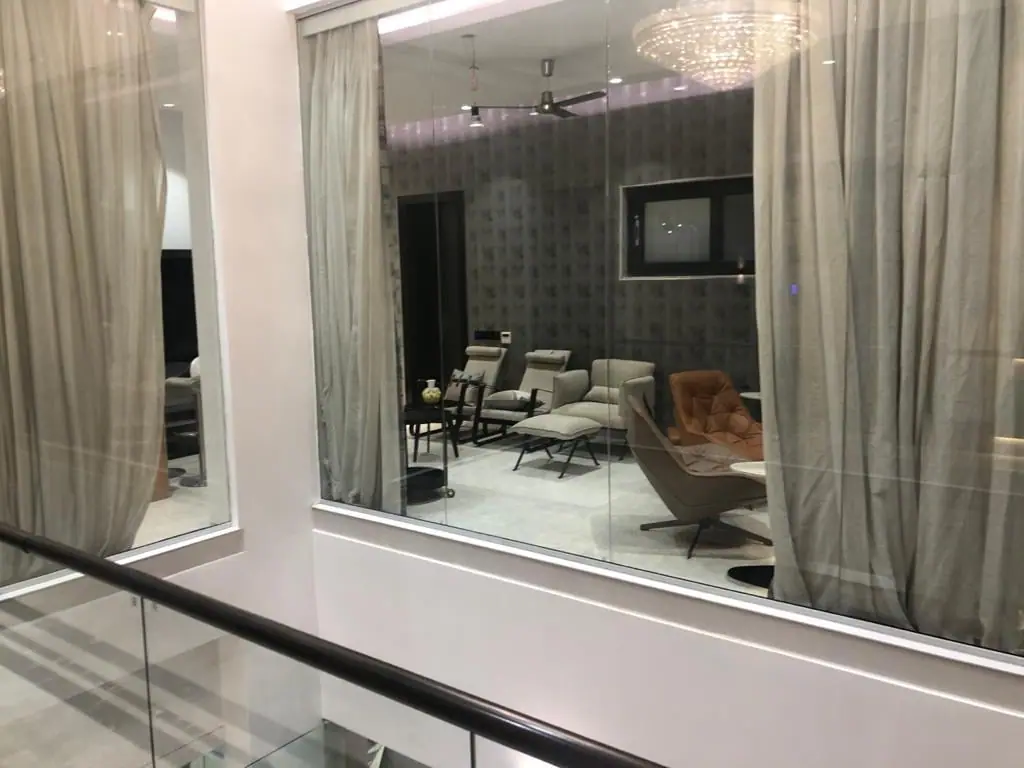Lounge seen through a glass wall from the staircase landing
