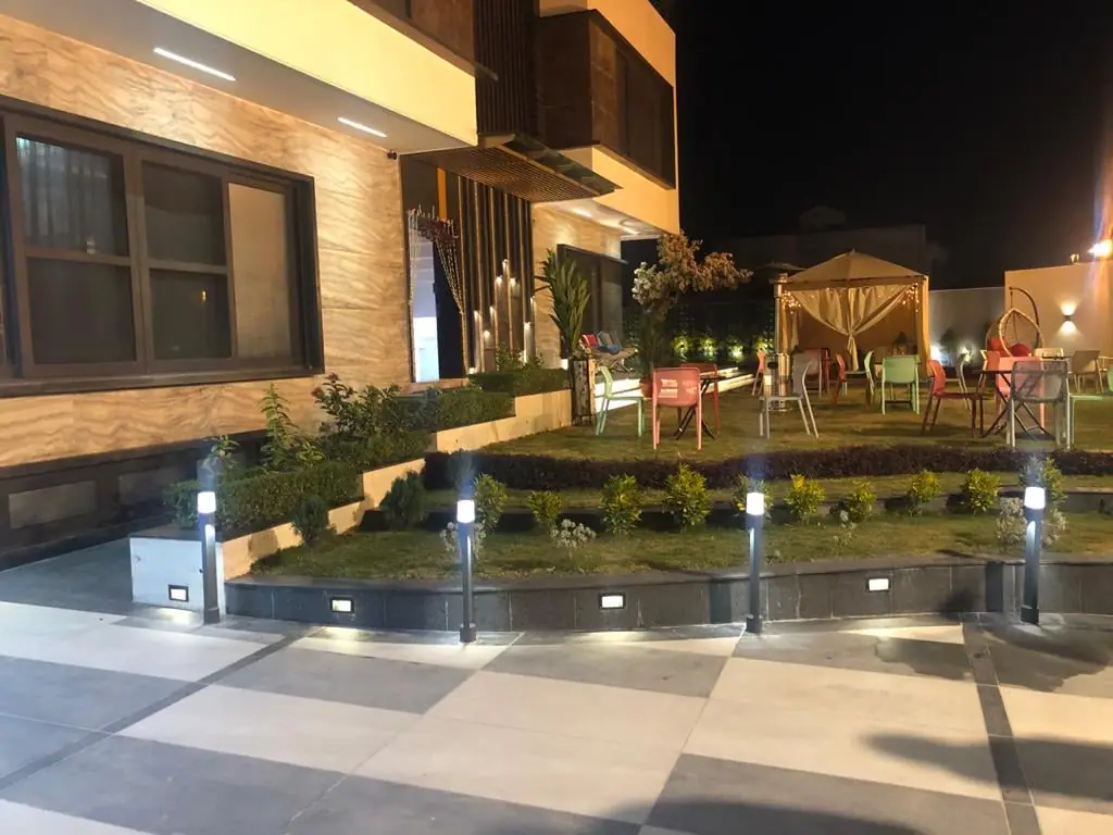 Garden terrace and pavilion lit at night