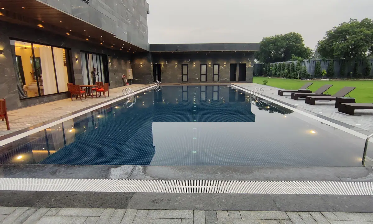 Pool terrace at Riviera Farmhouse at dusk