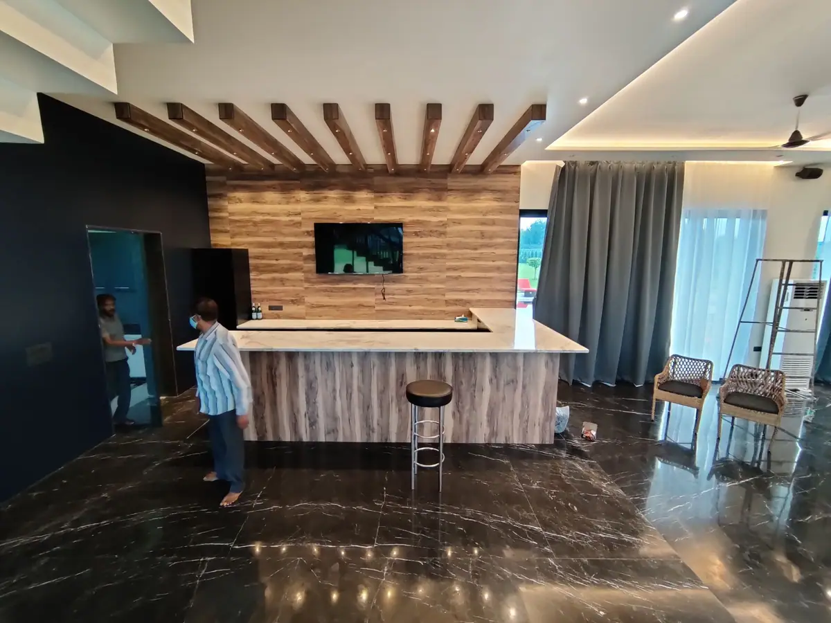 Home bar with timber panelling, beam ceiling and stone counter