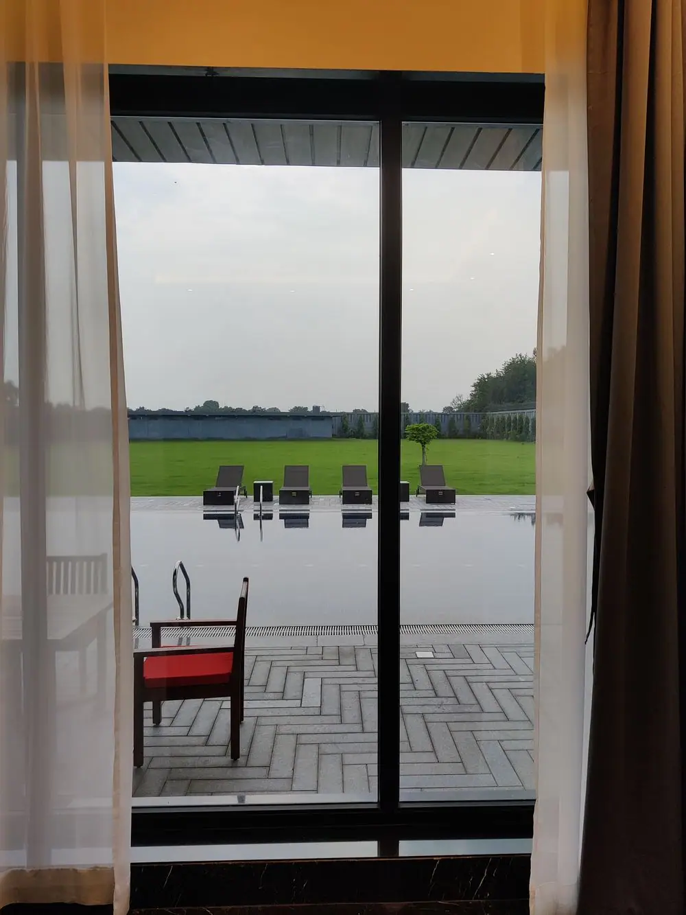 Bedroom at Riviera House opening onto the pool