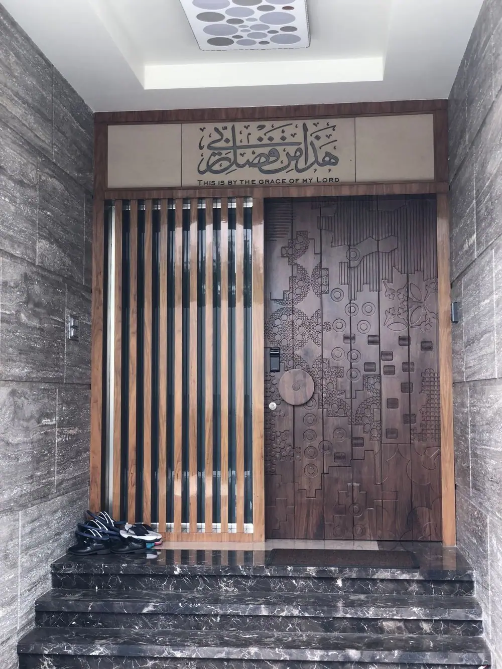 Carved timber entrance door with calligraphy panel