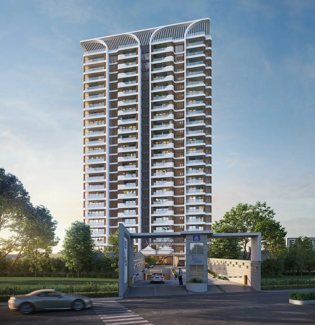 Shree Krishna Ratan Apartment tower at dusk, seen from the entrance gate